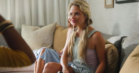 Woman enjoying casual gathering on cozy sofa indoors