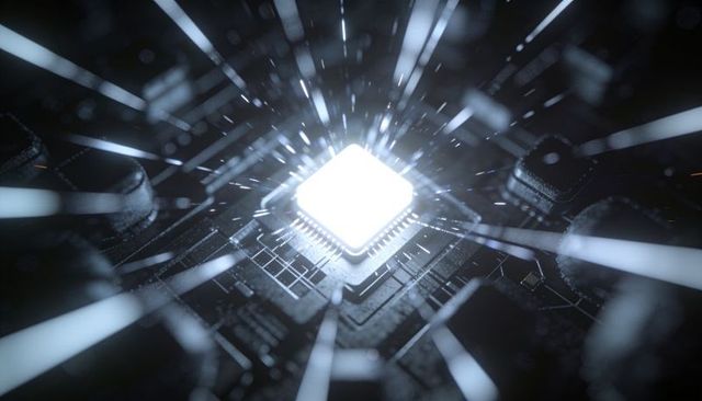 Glowing microprocessor emitting white-blue light on dark pcb with radiant traces