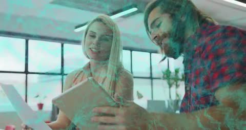 Coworkers Discussing Documents in Tech-Themed Office