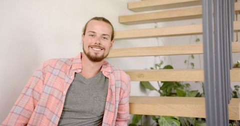 Young Man Smiling in Modern Home Interior
