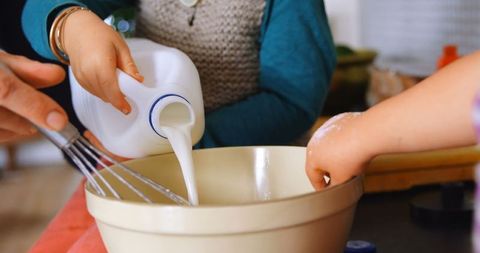 Family bonding in kitchen with milk preparation activity
