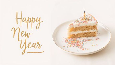 Minimal pastel new year cake slice with lit candle and gold script greeting