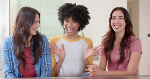 Diverse Female Friends Laughing at Kitchen Counter