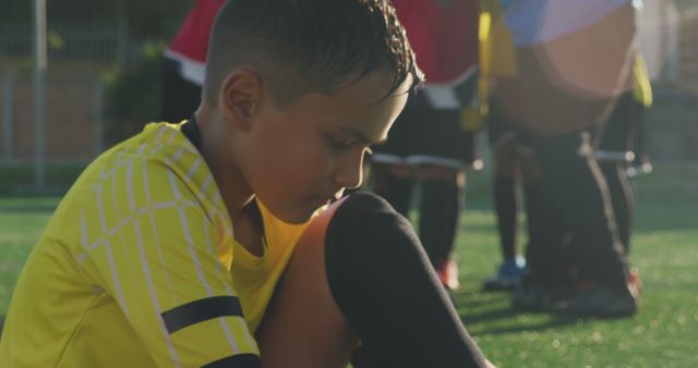 Disappointed Young Soccer Player Sitting on Field After Match - Download Free Stock Images Pikwizard.com