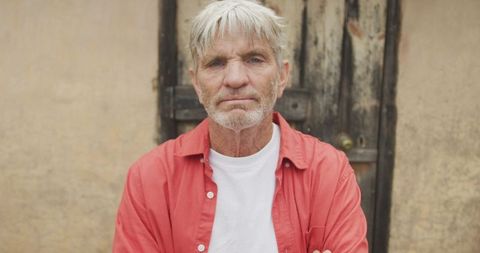 Confident Senior Man Standing with Arms Crossed Outdoors