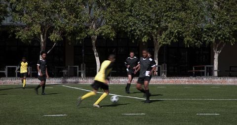 Teenage Soccer Players Competing in Intense Outdoor Football Match