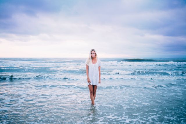 Woman Standing in Ocean at Sunset - Download Free Stock Photos Pikwizard.com