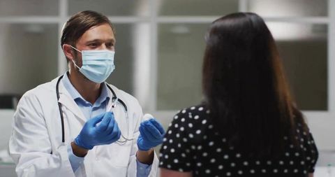 Doctor preparing injection for patient in medical consultation