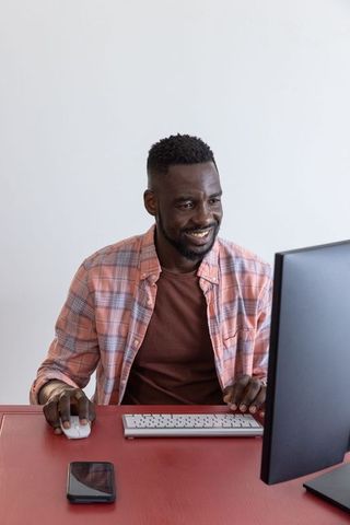 Smiling professional at work with modern technology