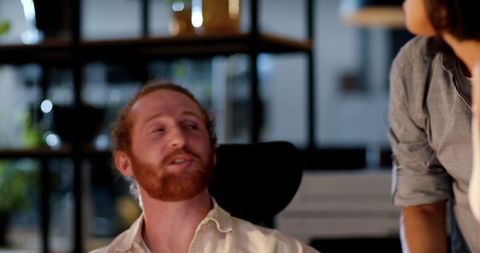 Colleagues Collaborating in Modern Office for Late-Night Project