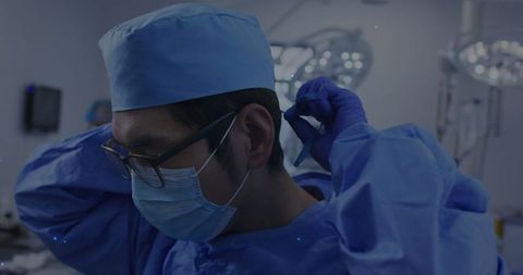 Surgeon Preparing for Operation in High-Tech Operating Room