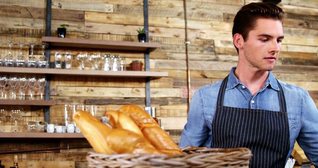 Male Baker Holding Basket with Fresh Baguettes in Rustic Bakery Décor - Download Free Stock Images Pikwizard.com