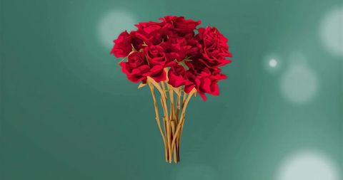 Floating red rose bouquet with golden stems on teal bokeh background for luxury romance