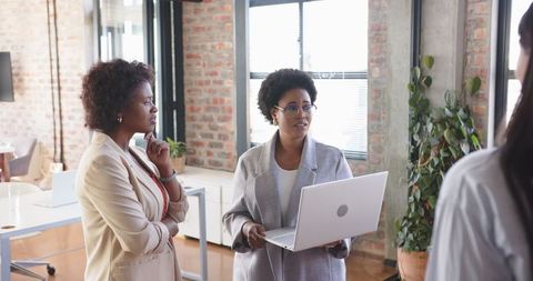 Diverse Female Colleagues Engaging in a Professional Meeting