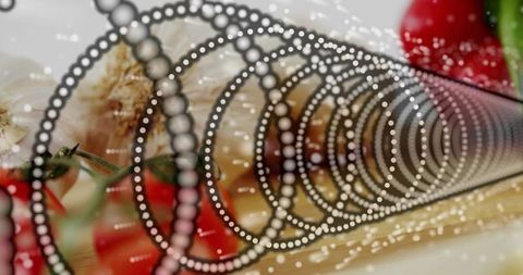 Featuring dotted spiral perforated tube with garlic cloves and cherry tomatoes on wooden board