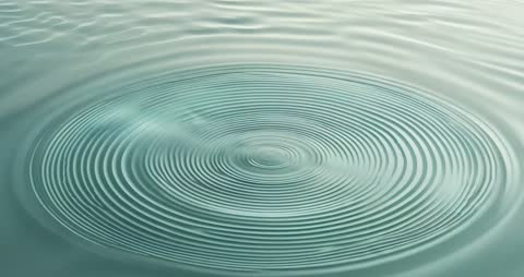 Ripple Effect from Droplet in Tranquil Turquoise Pond