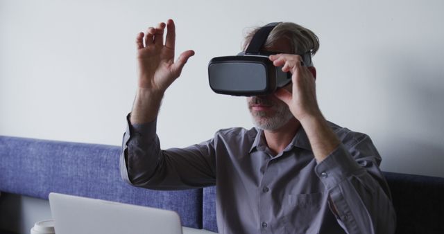 Man Experiencing Virtual Reality in Office with VR Headset - Download Free Stock Images Pikwizard.com