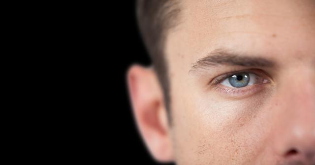 Digital composite of Close up of man's face against black background