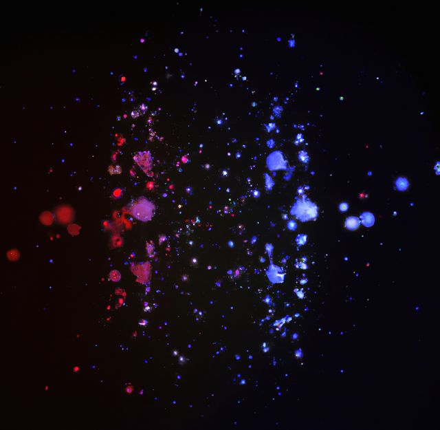 This abstract background features vibrant red and blue hues blending together, creating a galactic and space-like feel. The glowing elements and star-like particles make it perfect for use in digital art, sci-fi projects, wallpapers, or as a background for any creative design that needs a mystical and cosmic touch.