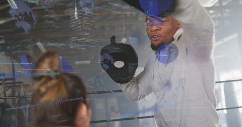 Boxing Coach Holding Focus Mitt While Guiding Trainee with Augmented Reality Overlays
