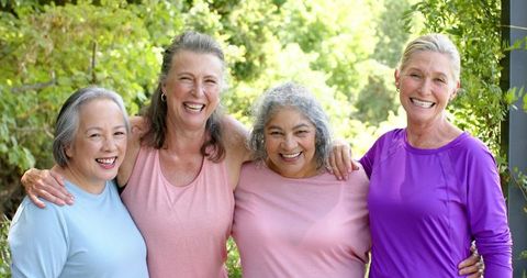 Senior women laughing together outdoors showcasing friendship