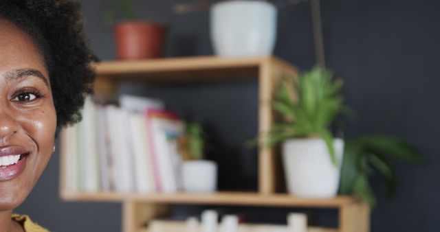 Smiling Woman in Home Office with Shelves and Plants in Background - Download Free Stock Images Pikwizard.com