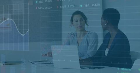 Businesswomen Analyzing Market Data in Modern Corporate Office