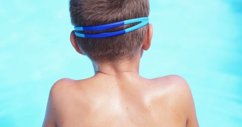 Rear View of Boy Wearing Swim Goggles by Poolside