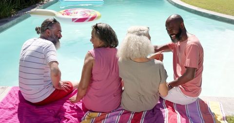 Senior Friends Relaxing by Poolside Engaging in Conversation - Download Free Stock Images Pikwizard.com