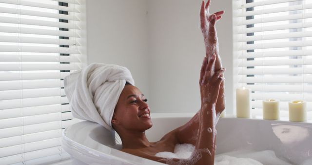 Woman Relaxing in Bathtub with Candles and Towel Wrapped Hair - Download Free Stock Images Pikwizard.com