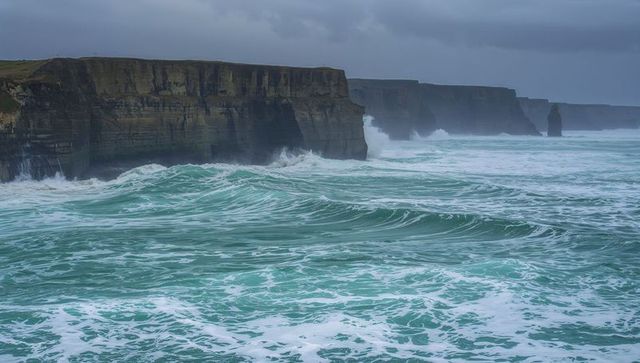 Majestic sea cliffs with powerful waves crushing against shoreline