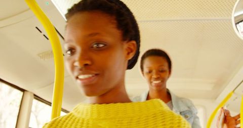 Smiling african american twin sisters on bus journey