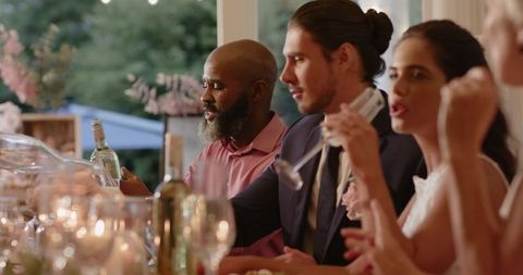 Guests toasting at outdoor wedding celebration