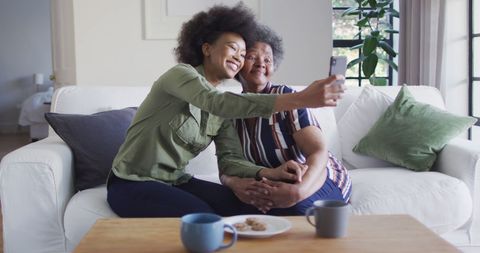 Afro American Mother and Daughter Taking Selfie on Couch - Download Free Stock Images Pikwizard.com