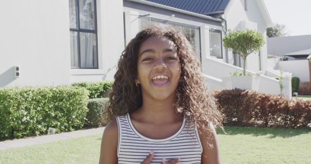 Happy Young Girl Smiling Outdoors in Front of Modern House - Download Free Stock Images Pikwizard.com