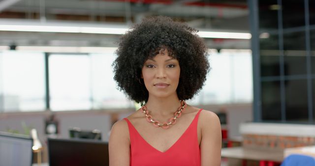 Confident Businesswoman with Curly Hair in Modern Office Environment - Download Free Stock Images Pikwizard.com