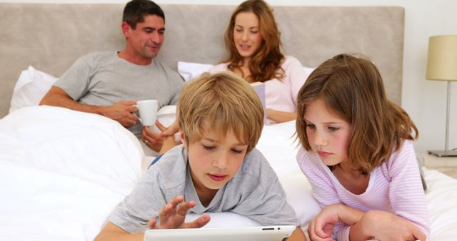 Modern Family Bonding Time with Digital Tablet in Cozy Bedroom - Download Free Stock Images Pikwizard.com