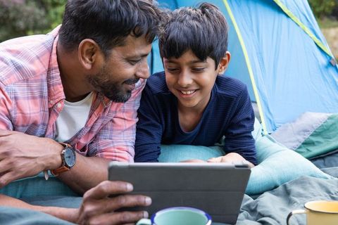 Father and Son Exploring on Tablet During Camping