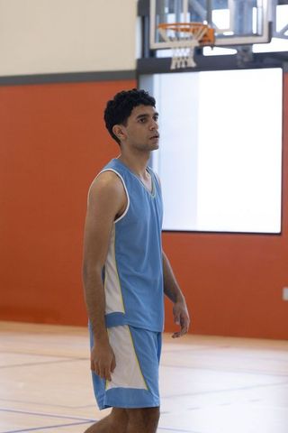 Focused Basketball Player Intently Perusing Game on Indoor Court