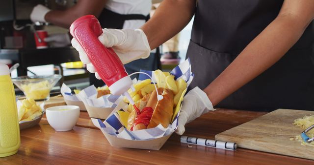 Food Vendor Adding Ketchup to Hot Dog at Outdoor Market - Download Free Stock Images Pikwizard.com