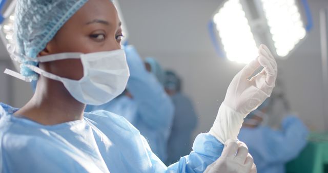 Focused Surgeon Putting On Gloves In Operating Room - Download Free Stock Images Pikwizard.com