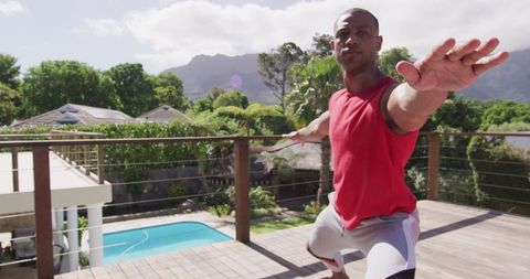 Man Practicing Outdoor Yoga on Balcony with Scenic View
