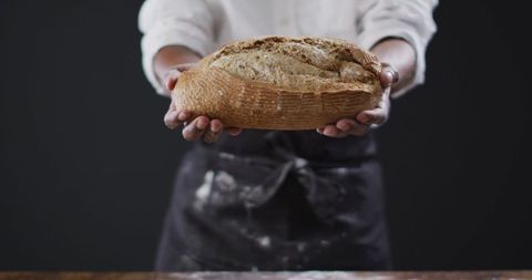 Baker Presenting Freshly Baked Artisan Bread