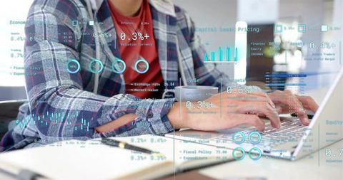 Flannel-clad professional typing on laptop analyzing data dashboards with hud overlays