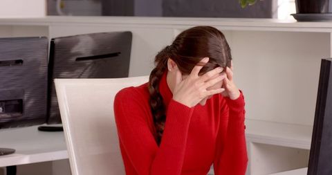 Businesswoman Stressed in Modern Office Setting