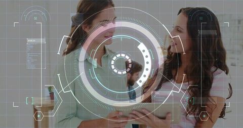 Two colleagues holding tablet discussing data with HUD overlay for teamwork and innovation