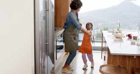 Mother and Daughter Baking in Bright Modern Kitchen