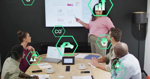 Presenter Pointing at Wall Display with Augmented Reality Icons During Boardroom Meeting