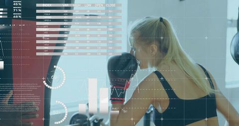 Woman training with data overlay in futuristic boxing gym