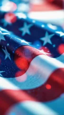 Vertical rippling American flag with cinematic red blue bokeh lights for patriotic video background